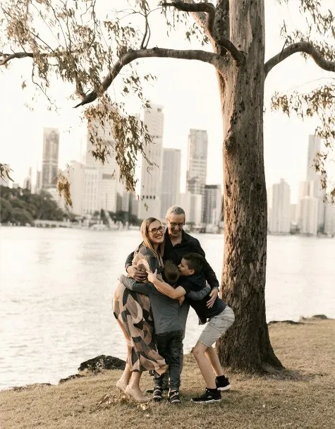 Sophie with her family beside the Brisbane River